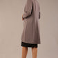 Model wearing the Diva Alverstone Coat in Mist Pink and black back image  with pockets