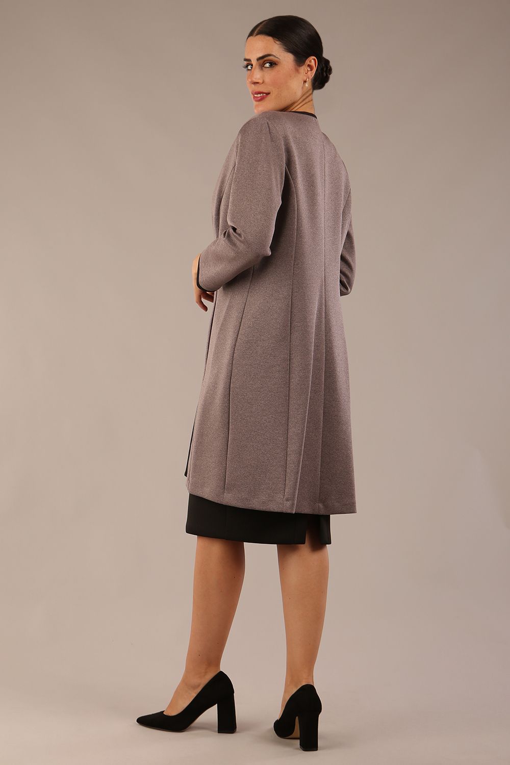 Model wearing the Diva Alverstone Coat in Mist Pink and black back image  with pockets