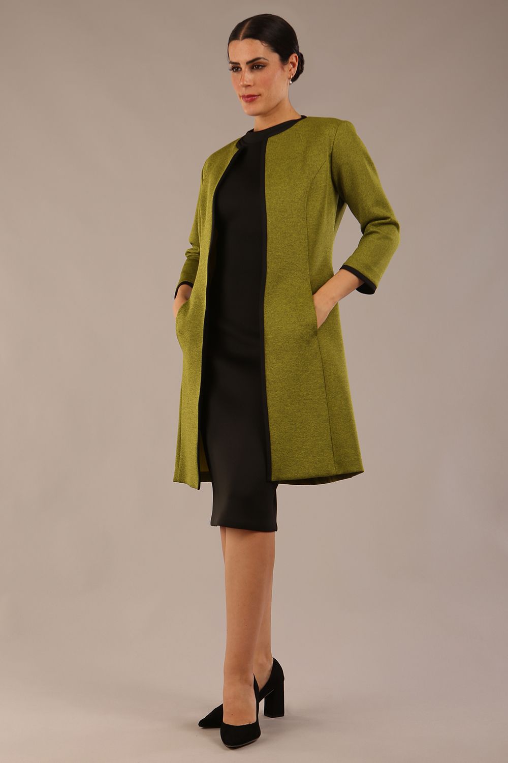 Model wearing the Diva Alverstone Coat in Amber green and black front image  with pockets