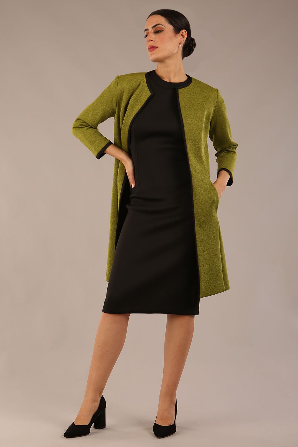 Model wearing the Diva Alverstone Coat in Amber green and black front image    