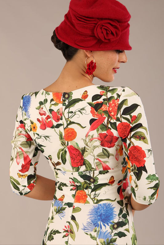 brunette model is wearing a diva catwalk Cynthia Floral Print Dress sleeved crossover v neckline knee length in Eden Print back image