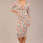 brunette model is wearing a diva catwalk Cynthia Floral Print Dress sleeved crossover v neckline knee length in Linear Tulip Print front image