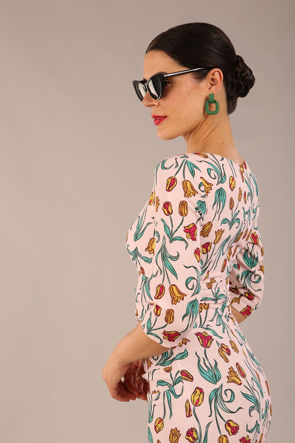 brunette model is wearing a diva catwalk Cynthia Floral Print Dress sleeved crossover v neckline knee length in Linear Tulip Print back image