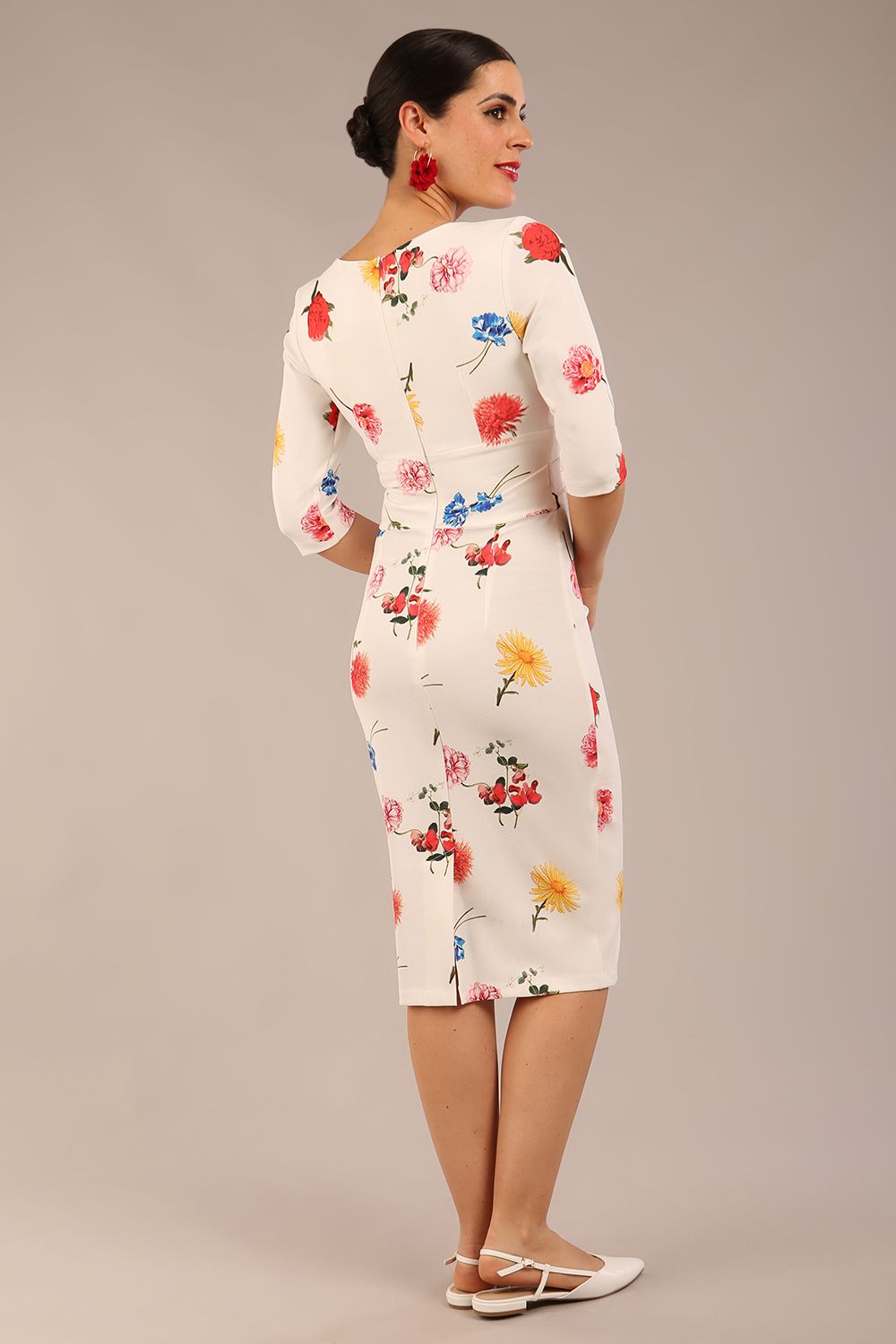 brunette model is wearing a diva catwalk Cynthia Floral Print Dress sleeved crossover v neckline knee length in Buttercup Print back image