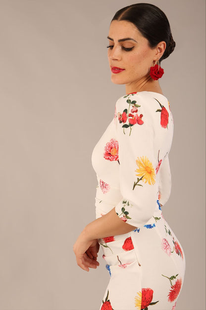 brunette model is wearing a diva catwalk Cynthia Floral Print Dress sleeved crossover v neckline knee length in Buttercup Print back image