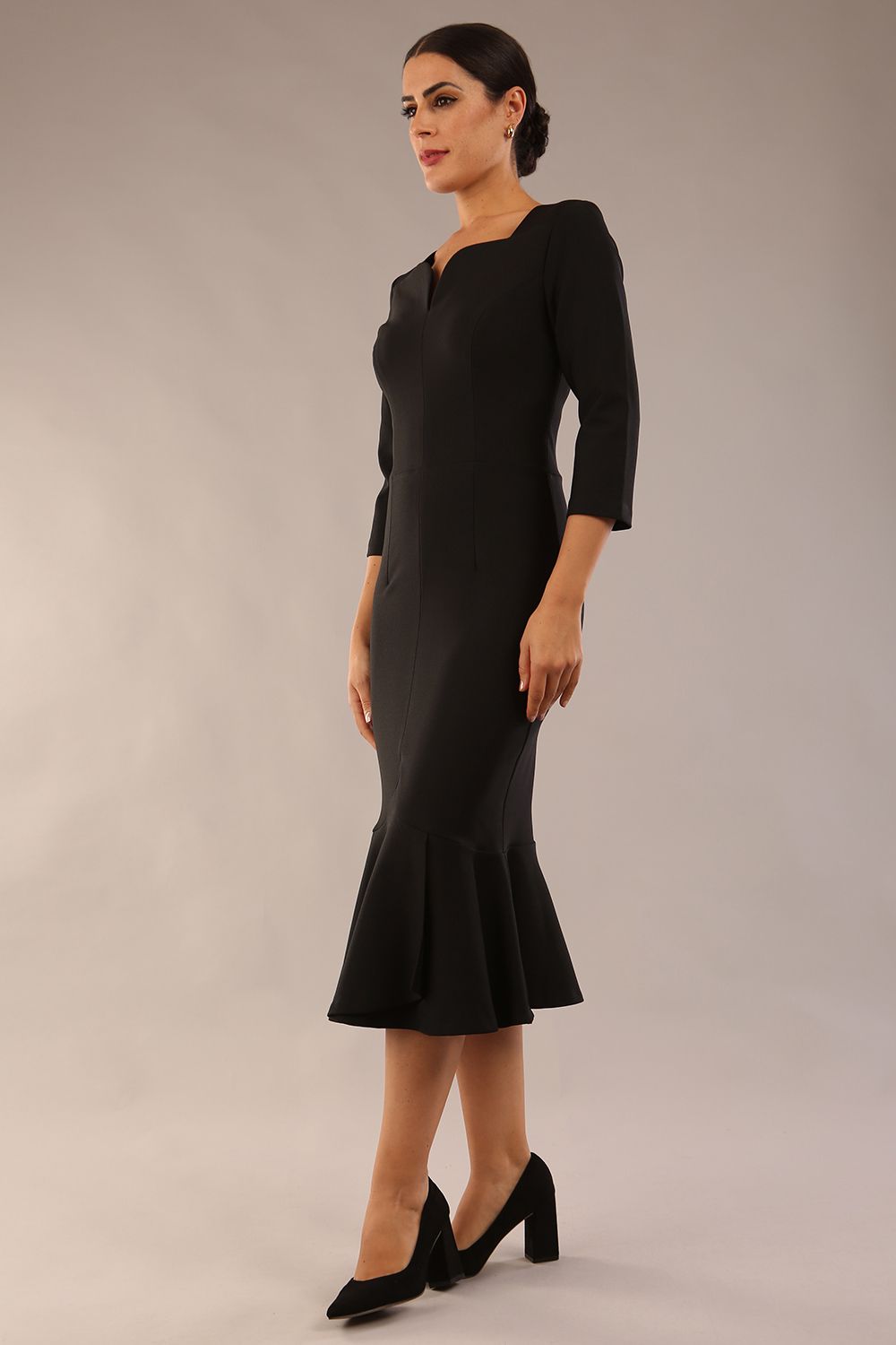 model is wearing a diva catwalk Seed Brecon Fishtail Sleeved Dress in black colour side front