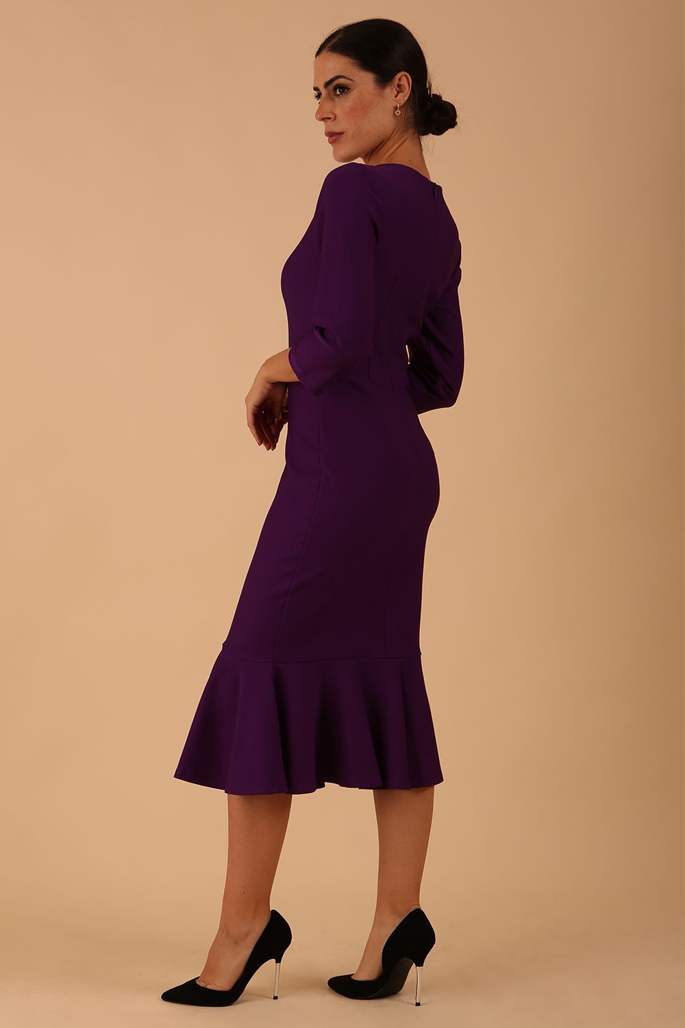 model wearing a diva catwalk Seed Brecon Fishtail Sleeved Dress in imperial purple colour