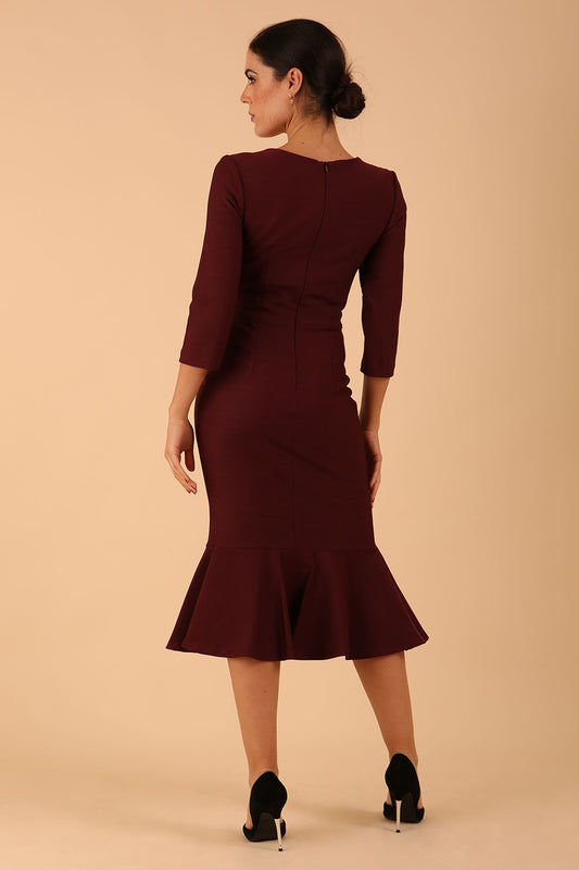 model wearing a diva catwalk Seed Brecon Fishtail Sleeved Dress in port royale colour