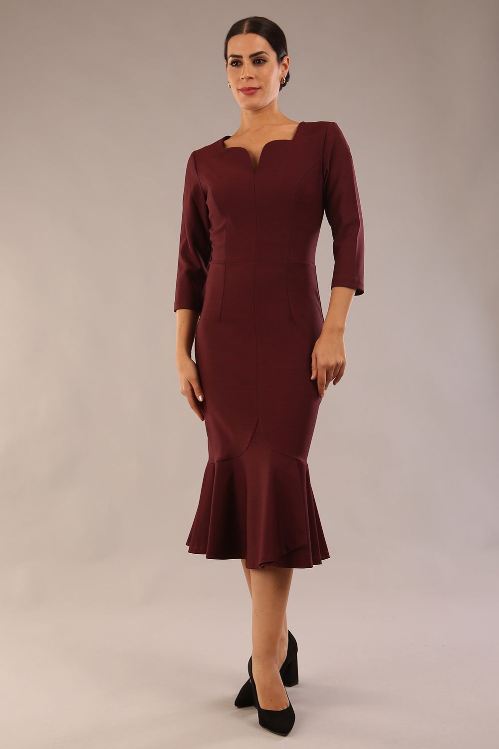 model is wearing a diva catwalk Seed Brecon Fishtail Sleeved Dress in port royale colour front