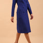 Brunette model wearing a diva catwalk Seed Silverstone Long Sleeve Coat Dress with 6 buttons across the front and pockets in colour Monaco Blue front side