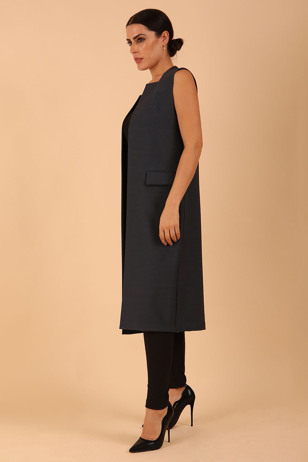 model wearing a divacatwalk Seed Harvard Sleeveless Coat midi length in Slate Grey colour front side