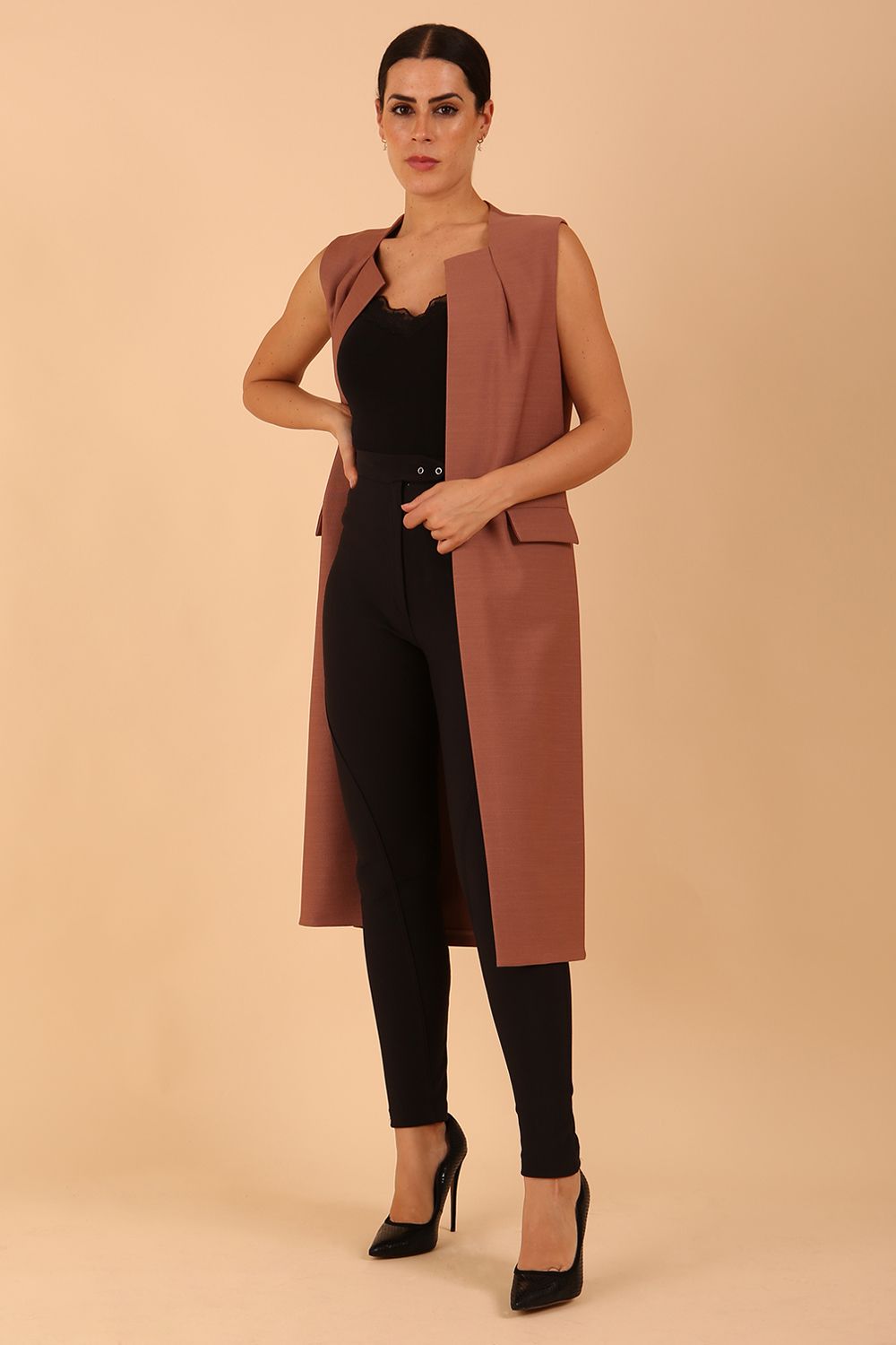 model wearing a divacatwalk Seed Harvard Sleeveless Coat midi length in Acorn Brown colour front