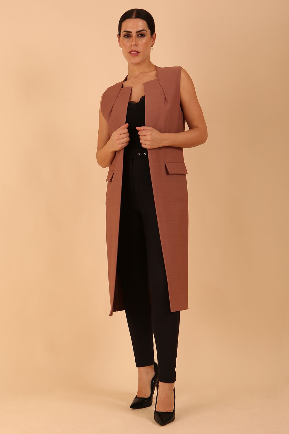 model wearing a divacatwalk Seed Harvard Sleeveless Coat midi length in Acorn Brown colour front