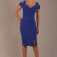 Woman wearing a riviera blue diva catwalk hayward pencil dress with short sleeves against a beige background
