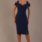 Woman wearing a navy blue diva catwalk hayward pencil dress with short sleeves against a beige background
