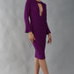 model is wearing diva catwalk fifi pencil skirt dress with three quarter flute sleeve and rounded neckline with a cut out at the front in magic purple 