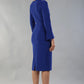 model is wearing diva catwalk fifi pencil skirt dress with three quarter flute sleeve and rounded neckline with a cut out at the front in cobalt blue