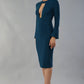 model is wearing diva catwalk fifi pencil skirt dress with three quarter flute sleeve and rounded neckline with a cut out at the front in glorious teal