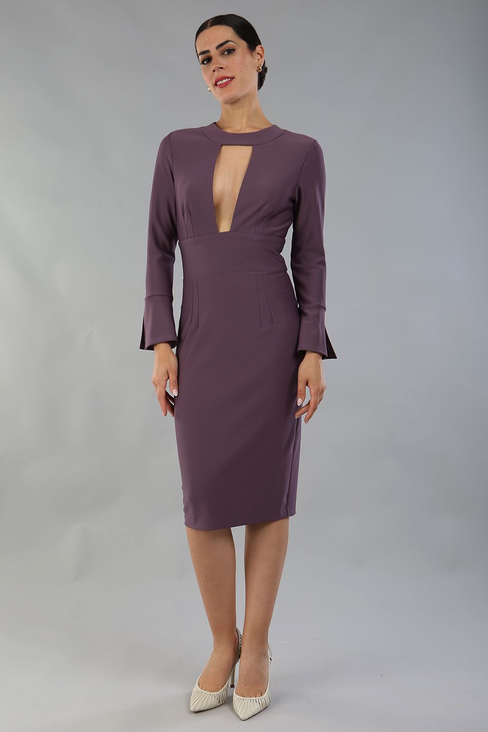 model is wearing diva catwalk fifi pencil skirt dress with three quarter flute sleeve and rounded neckline with a cut out at the front in mauve