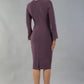 model is wearing diva catwalk fifi pencil skirt dress with three quarter flute sleeve and rounded neckline with a cut out at the front in mauve