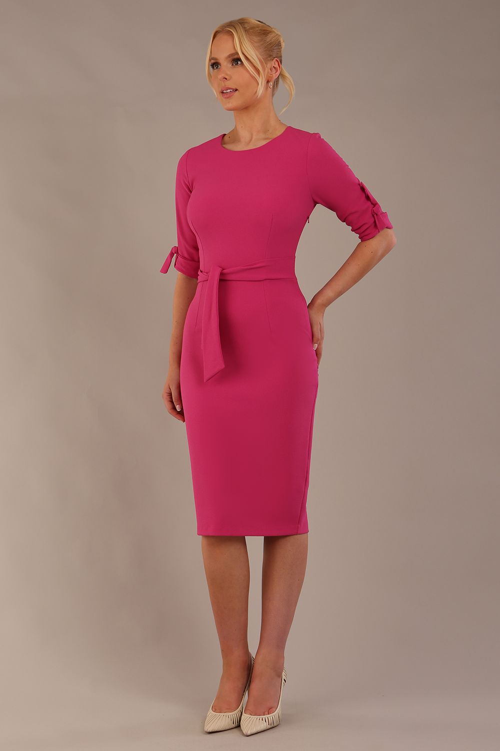 model wearing diva catwalk tryst pencil pink dress with sleeves and belt detail at the front with rounded neckline front (Fuchsia Pink)