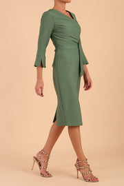 Model wearing diva catwalk Seed Orla Asymmetric Pencil Dress in Garden Green front side