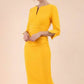 blonde model wearing seed tuscany pencil fitted dress in daffodil yellow colour with a split in the neckline and split detail on sleeves front (Daffodil Yellow)