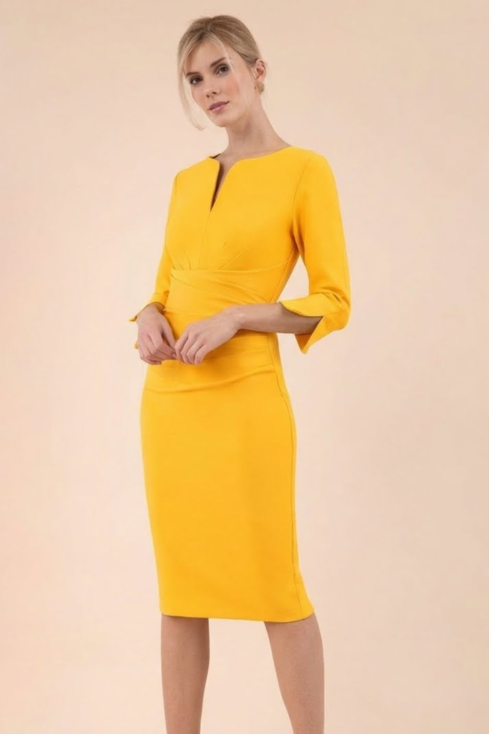 blonde model wearing seed tuscany pencil fitted dress in daffodil yellow colour with a split in the neckline and split detail on sleeves front (Daffodil Yellow)