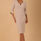 model wearing seed couture zara pencil skirt dress with asymmetric neckline with sleeves in sandy cream colour