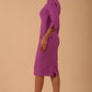 model wearing seed couture zara pencil skirt dress with asymmetric neckline with sleeves in magenta mist colour