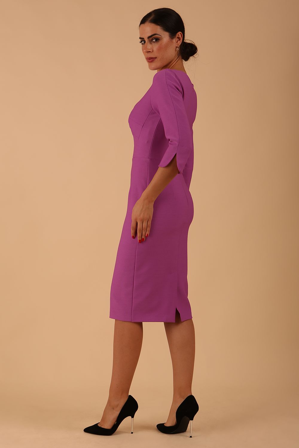 model wearing seed couture zara pencil skirt dress with asymmetric neckline with sleeves in magenta mist colour