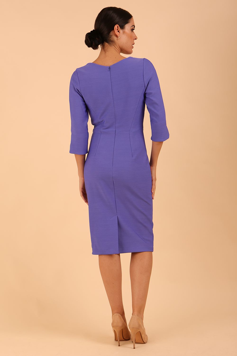 model wearing seed couture zara pencil skirt dress in dawn indigo with asymmetric neckline with sleeves back