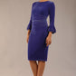 model is wearing a diva catwalk Winsford Velvet Dress with 3/4 peplum sleeve and rushing details knee length pencil dress in Royal Blue velvet colour