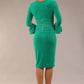 model is wearing a diva catwalk Winsford Velvet Dress with 3/4 peplum sleeve and rushing details knee length pencil dress in Golf green velvet colour