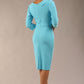 A model is wearing a bistretch pencil three quarter sleeve  and assymetric nackline dress by Diva Catwalk in sky blue