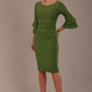 A woman wearing a vineyard green knee-length diva catwalk meridian pencil dress with a round neckline, double layered peplum three quarter length sleeves, and standing against a plain background.