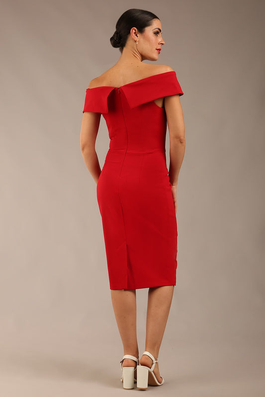 brunette model wearing diva catwalk pencil skirt dress sleeveless with lowered neckline and pleating on side in scarlet red colour back image