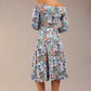brunette model is wearing a diva catwalk islay a-line wing print dress off shoulder and knee length in water garden print back image