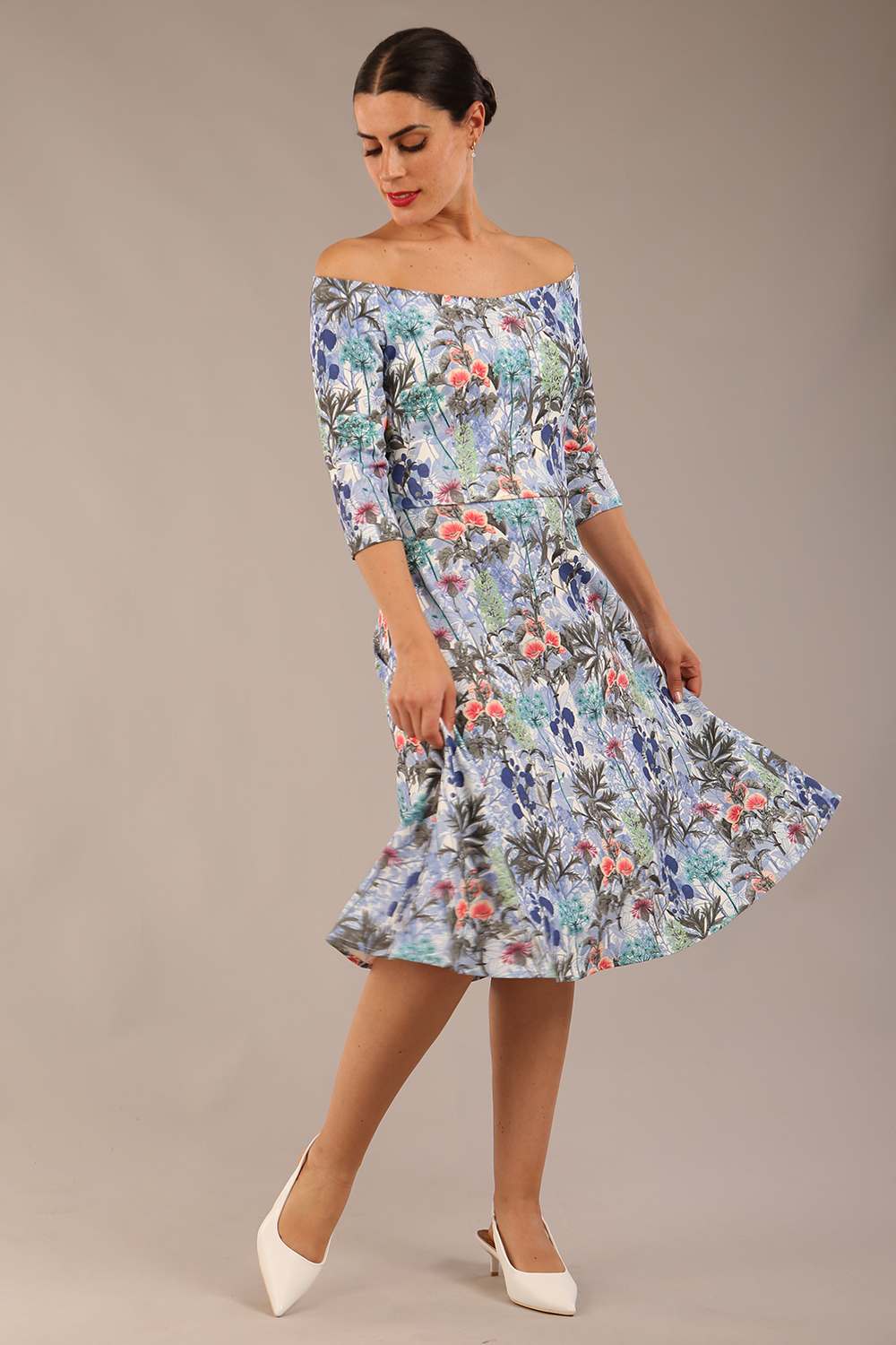 brunette model is wearing a diva catwalk islay a-line wing print dress off shoulder and knee length in water garden print front image