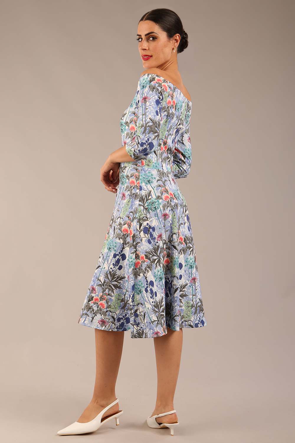 brunette model is wearing a diva catwalk islay a-line wing print dress off shoulder and knee length in water garden print front image
