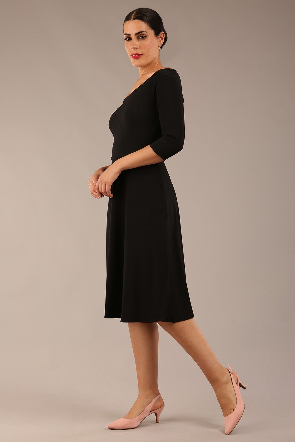 brunette model is wearing diva catwalk off shoulder swing a-line islay dress with sleeves in black colour front image 