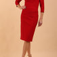 brunette model wearing diva catwalk couture althorp pencil fitted dress with sleeves and rounded neckline and bow detail at the top in cardinal red colour front