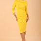 model wearing diva catwalk york pencil-skirt dress with sleeves and rounded folded collar and plearing across the tummy area in Blazing Yellow colour front