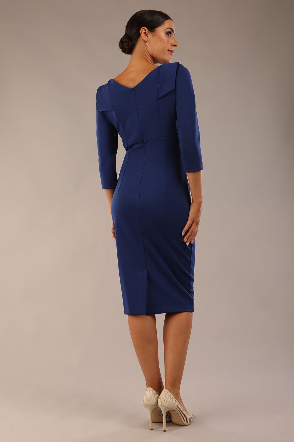 model wearing diva catwalk york pencil-skirt dress with sleeves and rounded folded collar and plearing across the tummy area in navy blue colour back