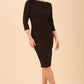 model wearing diva catwalk york pencil-skirt dress with sleeves and rounded folded collar and plearing across the tummy area in black colour front