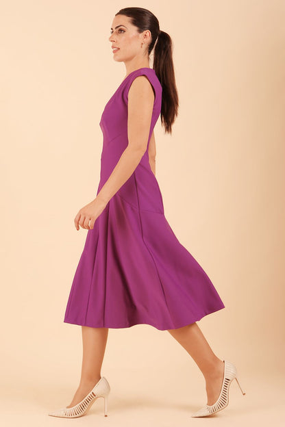 model wearing diva catwalk rochelle swing skirt a line dress without sleeves with a low v neck in royal purple side