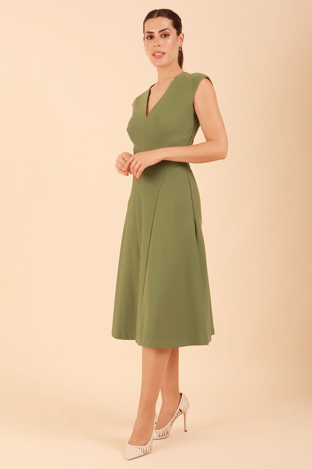 model wearing diva catwalk rochelle swing skirt a line dress without sleeves with a low v neck in vineyard green front