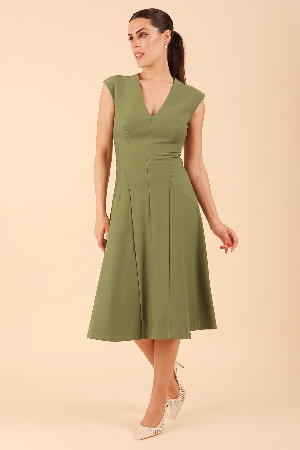 model wearing diva catwalk rochelle swing skirt a line dress without sleeves with a low v neck in vineyard green front