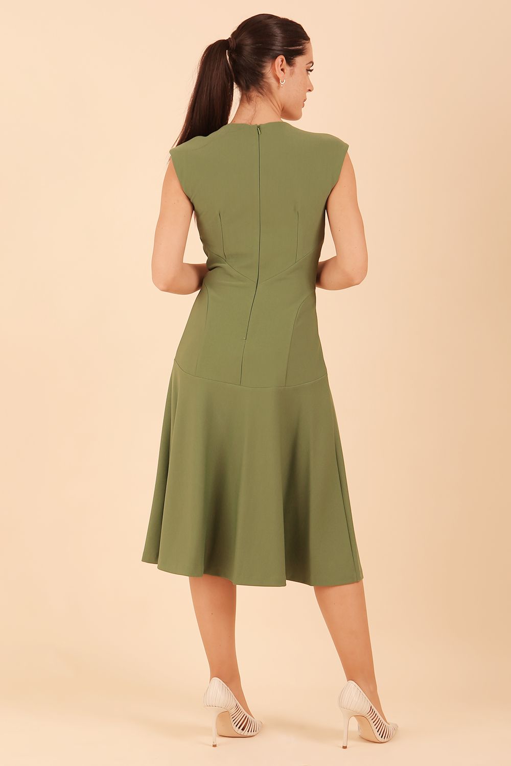 model wearing diva catwalk rochelle swing skirt a line dress without sleeves with a low v neck in vineyard green back