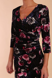 Model wearing Diva Catwalk Vella Asymmetric Dress 3/4 sleeve asymmetric hemline with v neckline in Rose Blossom Print front detail